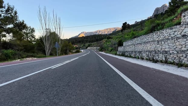 Explore a captivating winding road surrounded by beautiful landscapes and serene vistas, ideal for adventure