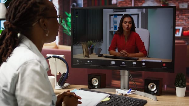 Woman doing videocall interview with human resources representative, applying for company position. Candidate at home doing teleconference meeting with HR employer, camera A