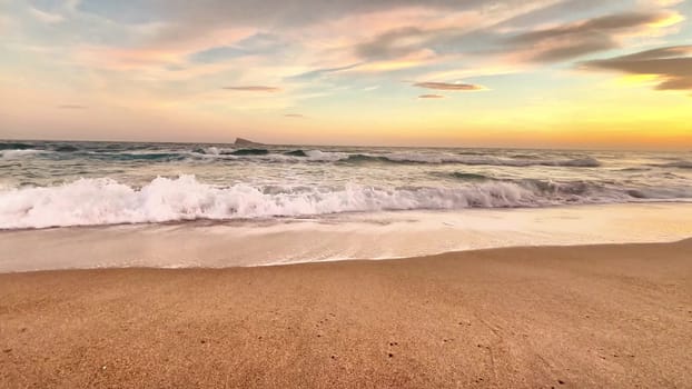 A tranquil beach scene that captures the gentle soft waves at sunset, ideal for relaxation and nature themes