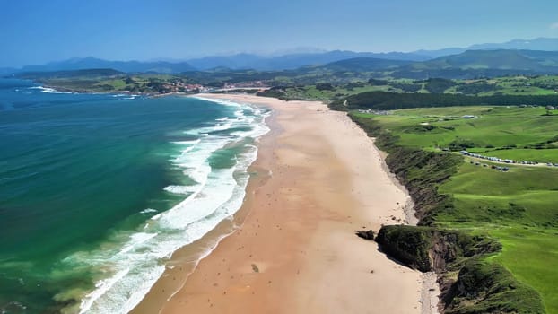 Explore this breathtakingly stunning beachscape with its golden sands and emerald waters beneath a bright blue sky