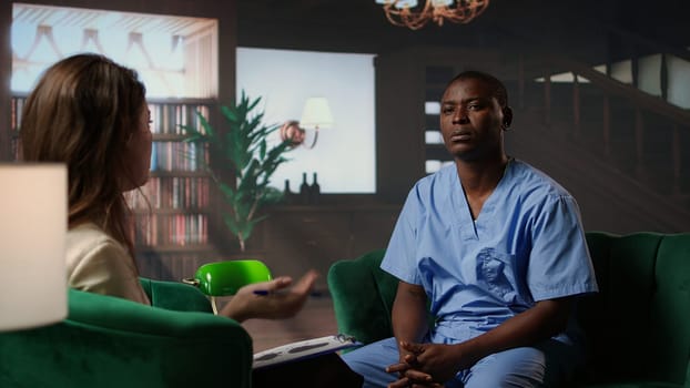 African american nurse struggles with depersonalization condition due to work PTSD, dealing with derealization and being in a dissociative state. Assistant at the hospital has anxiety. Camera A.