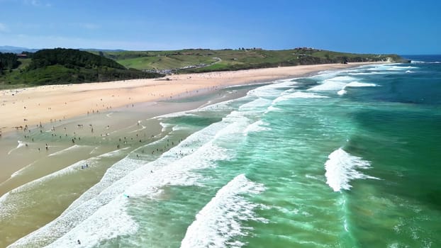 Breathtaking aerial view of a serene beach with aqua waves and golden sands, perfect for relaxation.