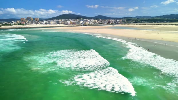 Aerial view highlights stunning turquoise waters, inviting sandy beaches, and vibrant coastal cityscape