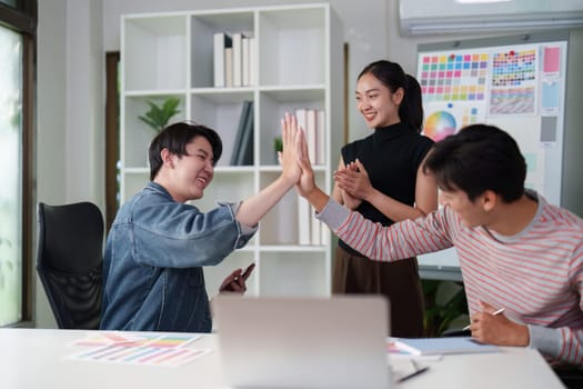 A graphic design team collaborates on a project, sharing insights and using digital tools to enhance their creative process. The atmosphere is lively and innovative, perfect for developing new ideas.