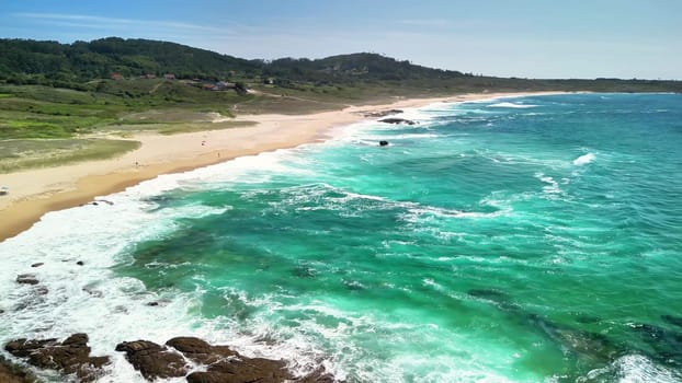 Come and explore this breathtaking beach scene, showcasing the stunning turquoise waves crashing onto golden sand
