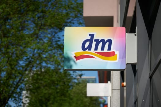 Berlin, Germany – May 01, 2025: Illuminated sign and company logo of the German drugstore chain dm in the city center of Berlin