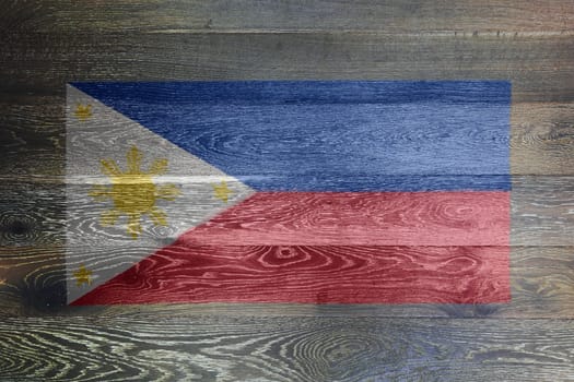A Philippines flag on rustic old wood surface background