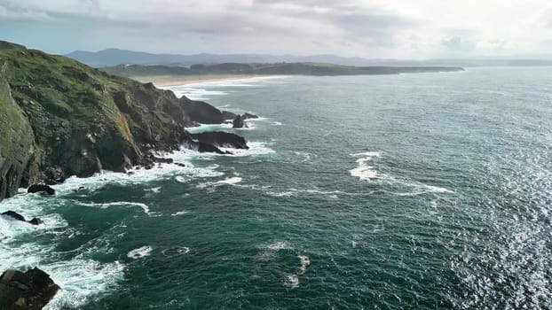 Experience breathtaking coastal landscapes filled with crashing waves and lush verdant cliffs reaching skyward