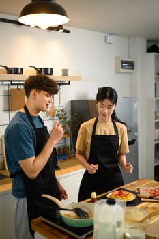 Young couple enjoying cooking together and creating a beautifully plated breakfast.