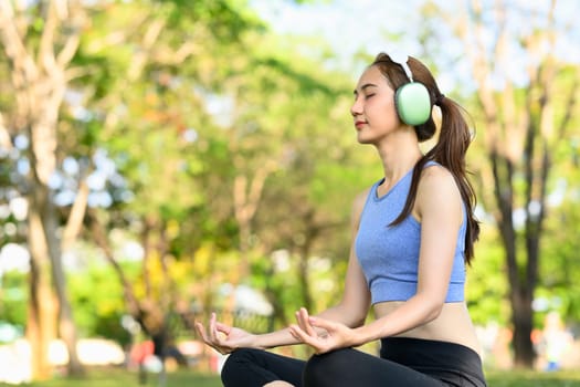 Peaceful woman listening to music or guided meditation through headphones.