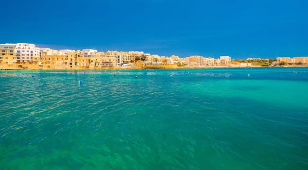 Beautiful cityscape of Birzebbuga, a small town in Malta. Picturesque seascape with turquoise transparent and clean sea water.