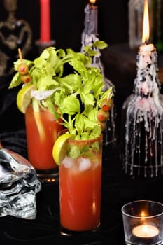 Bloody Mary cocktail. Tomato juice and vodka, garnished with celery stalk, lime and olives. Halloween party ideas.  