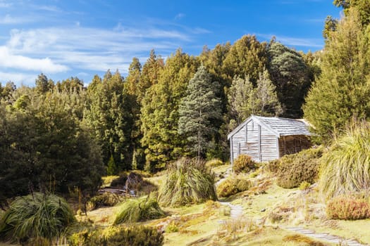 Iconic Du Cane Hut built by Patrick Joseph ‘Paddy’ Hartnett on the Overland Track is the oldest structure in the area. Photographed on a warm autumn morning in Cradle Mountain, Tasmania, Australia