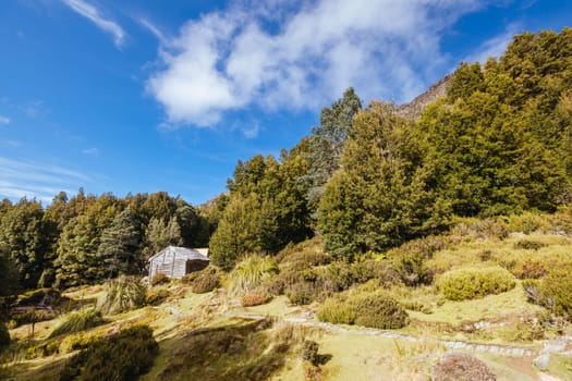 Iconic Du Cane Hut built by Patrick Joseph ‘Paddy’ Hartnett on the Overland Track is the oldest structure in the area. Photographed on a warm autumn morning in Cradle Mountain, Tasmania, Australia