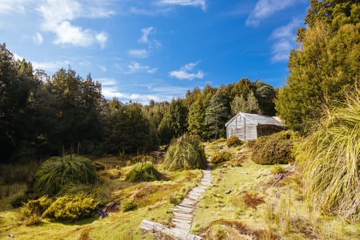Iconic Du Cane Hut built by Patrick Joseph ‘Paddy’ Hartnett on the Overland Track is the oldest structure in the area. Photographed on a warm autumn morning in Cradle Mountain, Tasmania, Australia