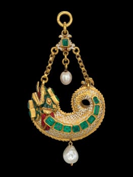 Ornate Spanish pendant from the late 16th to early 17th century, shaped like a stylized dragon. Features gold, vibrant enamel, emeralds, and pearls. Evokes historical artistry and mythical symbolism.