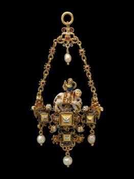 Charming European pendant, likely second half of the 19th century, depicting a youth playing a lyre while riding an ornate elephant. Features gold, enamel, gemstones, and pearls. Evokes imaginative artistry and historical curiosity
