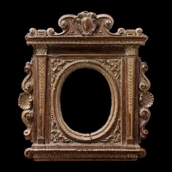 Detailed view of an antique tabernacle mirror frame, likely 16th century. Features rich wood carving, shell motifs, and an oval mirror reflecting blurred light. Evokes a sense of history and religious artistry.