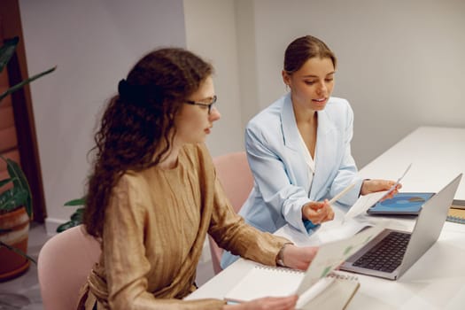 Two professionals discussing ideas in a modern office setting, focusing on collaboration and strategy.