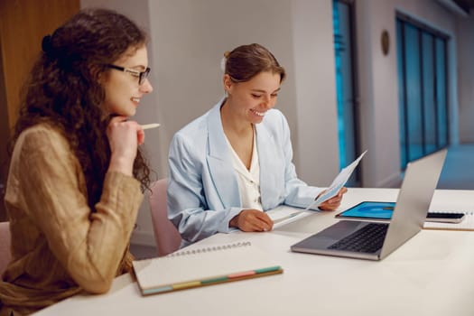 Two dedicated professionals are engaging in a highly productive work session at a modern and contemporary workspace