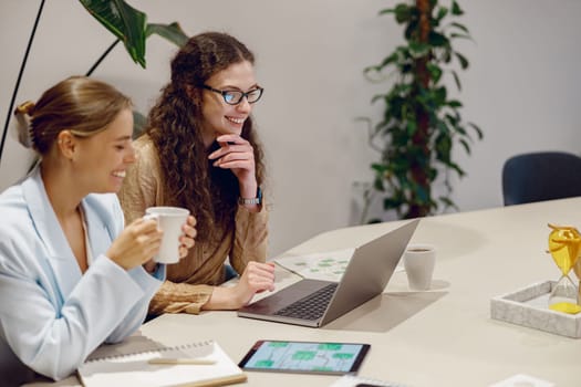 Two skilled professionals hold a productive meeting using advanced technology in a stylish workspace