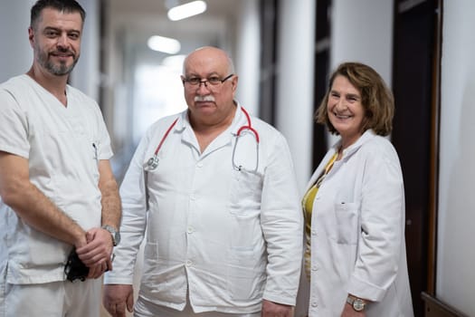 A team of experienced doctors standing in the hospital hallway, weary but dedicated after a long day of caring for patients