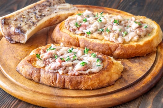 Herb-topped marrow melts into toasted bread, offering bold and buttery rustic indulgence