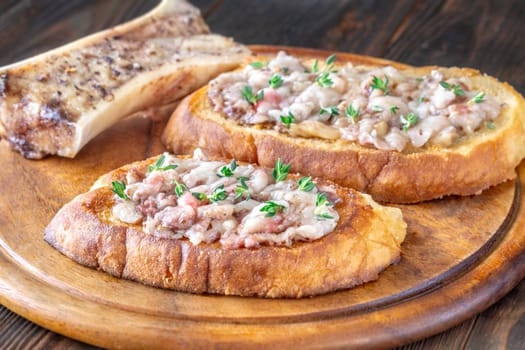 Herb-topped marrow melts into toasted bread, offering bold and buttery rustic indulgence