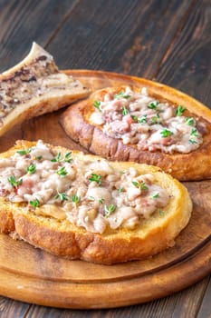 Herb-topped marrow melts into toasted bread, offering bold and buttery rustic indulgence