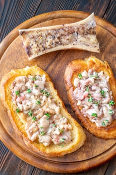 Herb-topped marrow melts into toasted bread, offering bold and buttery rustic indulgence