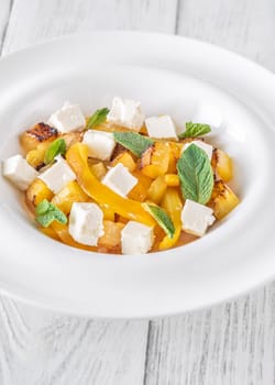 Sweet pineapple, grilled peppers, feta cubes, and mint mingle in vibrant salad