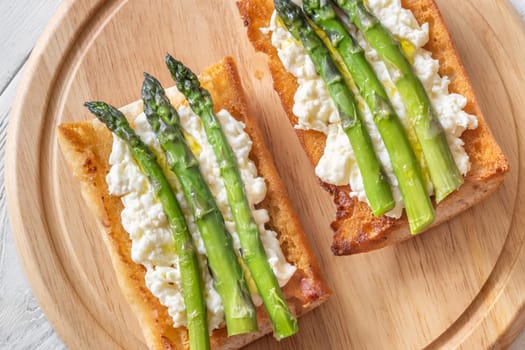 Toasted ciabatta holds creamy cheese and asparagus glistening in golden oil