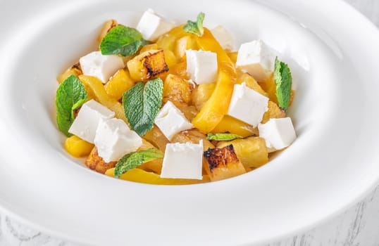 Sweet pineapple, grilled peppers, feta cubes, and mint mingle in vibrant salad