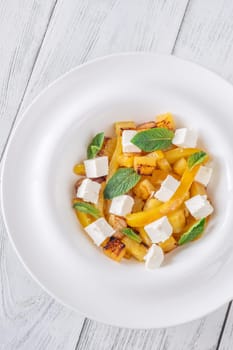 Sweet pineapple, grilled peppers, feta cubes, and mint mingle in vibrant salad