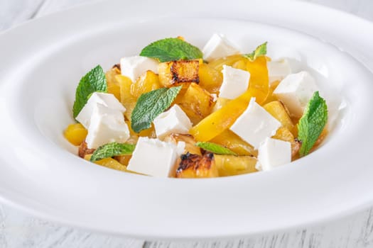 Sweet pineapple, grilled peppers, feta cubes, and mint mingle in vibrant salad