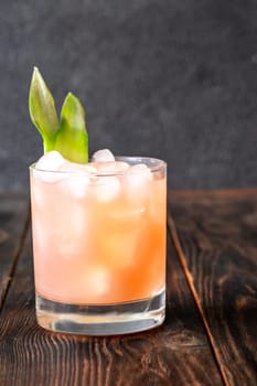 Vibrant drink blends guava, pineapple, lime, and rum in rich tropical harmony