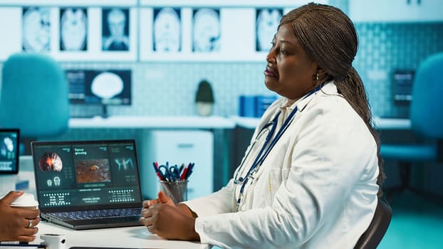 Female healthcare professional consulting a young girl patient, using advanced medical data and equipment to provide expert medical advice on prevention or recovery. Camera A.
