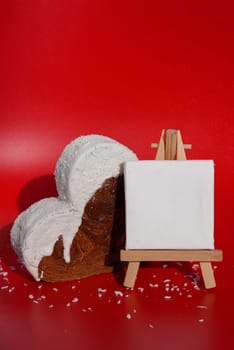 White paper note mockup template greeting holiday card Heart shaped coconut flavor croissant on red background with copy space. Puff pastry new trendy sweet dessert bakery. Creamy dough experiment
