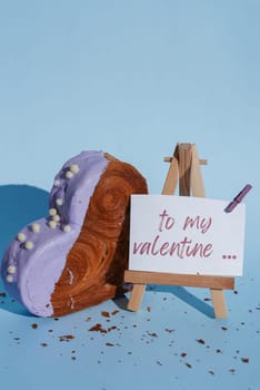 Valentine's Day TO MY VALENTINE wishes saying caption on greeting card Delightful and vibrant heartshaped pastry croissant treat, beautifully topped with colorful frosting galore. Copy space. Food experimentation viral dessert creative baking trend