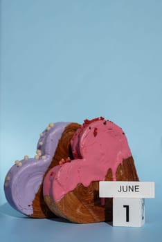 1 June International Children's day celebration greeting card Heart shaped two croissants on blue background with copy space. Puff pastry new trendy sweet dessert bakery. Creamy dough experiment