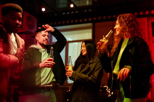 Four friends celebrate in a vibrant space, sharing laughter and drinks under colorful lights. The atmosphere is joyful, capturing the essence of companionship at night.