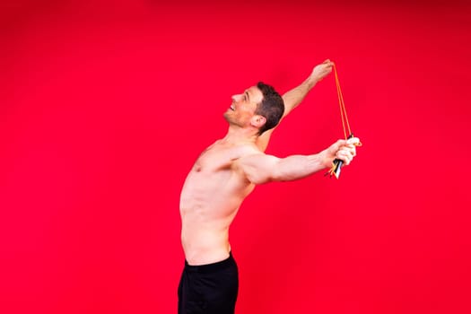 Portrait, happy man and bodybuilder with abs on a studio background, backdrop and topless pride
