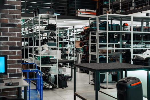 Shelves are stocked with various equipment and supplies in a spacious warehouse. The bright interior is bustling with activity, providing a sense of order and efficiency.
