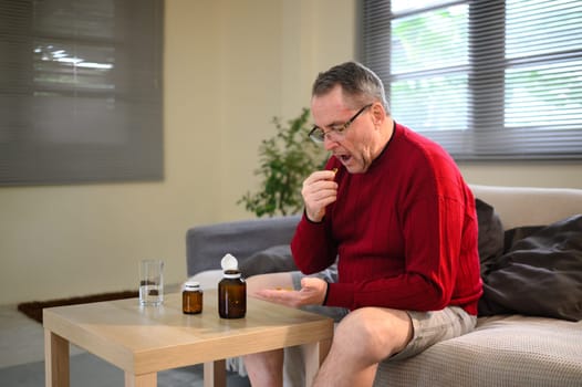 Mature adult consuming dietary supplements for a healthy lifestyle.