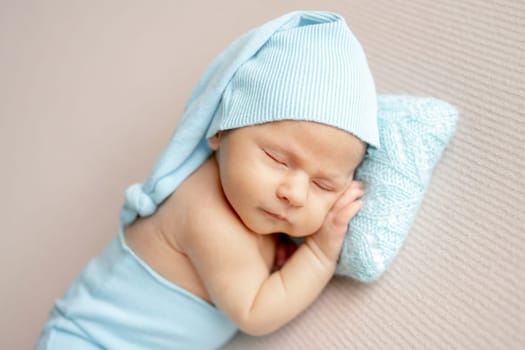 Studio Photo Of A Newborn Baby Sleeping In Turquoise Hat And Pants