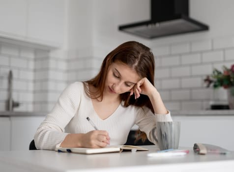 Focused Girl Writing In A Notebook Preparing For Classes At The Lyceum