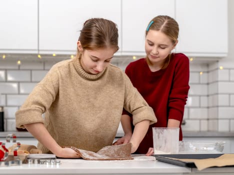 Little Sisters Making Dough For Gingerbread Cookies