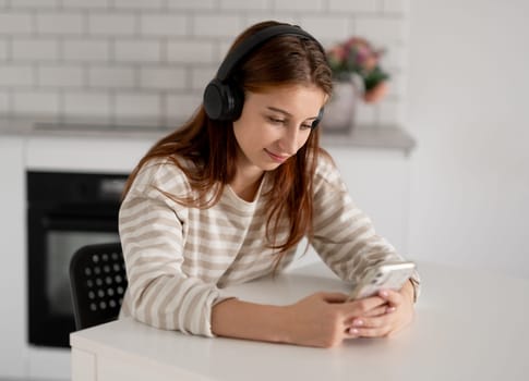 Happy Teen Girl Using Smartphone With Headphones