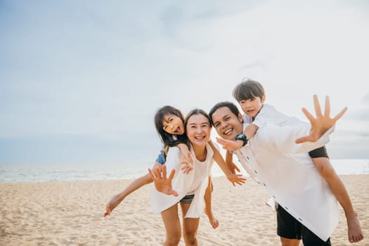 Beach fun with a happy family. Parents and children laughing playing and enjoying the sea. Summer holidays represent joy freedom and travel. A moment of relaxation and happiness