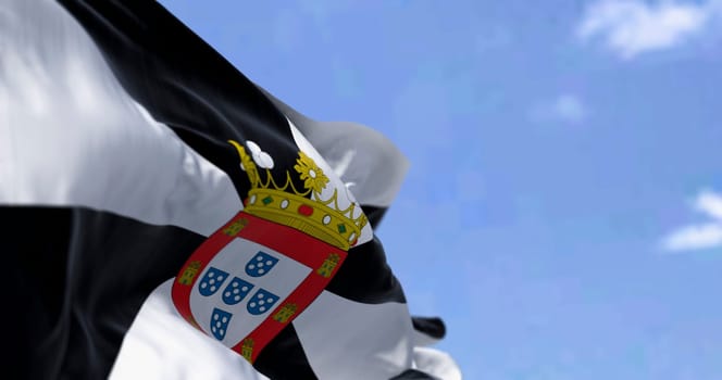 Ceuta flag waving. Ceuta is a Spanish autonomous city. Black and white gyronny with central escutcheon displaying the municipal coat of arms. 3d illustration render. Selective focus. Close-up